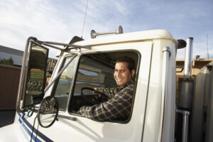 A trucker smiling in his cab